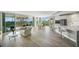 Open concept living space features hardwood floors, balcony, living area, dining, and modern kitchen at 385 N Point Rd # 404, Osprey, FL 34229