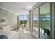 Bright bedroom with balcony access showing beautiful outside views, alongside quaint furniture pieces at 385 N Point Rd # 404, Osprey, FL 34229