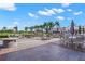 Enjoy outdoor dining on the spacious patio with ample seating, a fire pit, and views of lush landscaping and blue skies at 385 N Point Rd # 404, Osprey, FL 34229