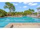 Beautiful swimming pool surrounded by mature trees and landscaping, offering a refreshing oasis for relaxation and recreation at 385 N Point Rd # 404, Osprey, FL 34229