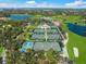 Aerial shot of well-maintained tennis courts amidst lush greenery and pristine golf courses at 385 N Point Rd # 404, Osprey, FL 34229