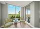 Corner view from the balcony with chairs and a table looking at the natural Florida landscape at 385 N Point Rd # 404, Osprey, FL 34229