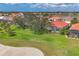 Beautiful backyard with lush green grass and mature trees overlooking the golf course providing plenty of privacy at 446 Pinewood Lake Dr, Venice, FL 34285