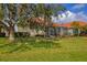 Lush backyard with a spacious, screened lanai, offering a serene outdoor living space at 446 Pinewood Lake Dr, Venice, FL 34285