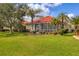 Well-maintained backyard with mature landscaping and a screened-in lanai for enjoying the outdoors at 446 Pinewood Lake Dr, Venice, FL 34285