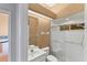 Bathroom featuring a vanity sink, toilet, and a glass-enclosed shower at 446 Pinewood Lake Dr, Venice, FL 34285
