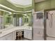Bright bathroom featuring a large mirror, vanity with white cabinets, and a glass-enclosed shower at 446 Pinewood Lake Dr, Venice, FL 34285