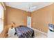 Cozy bedroom with neutral walls, ceiling fan, and minimal furnishings at 446 Pinewood Lake Dr, Venice, FL 34285