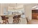 Bright kitchen with breakfast bar, white cabinets, tile floors, and modern appliances at 446 Pinewood Lake Dr, Venice, FL 34285