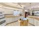 Spacious kitchen features tile flooring, wood countertops, white cabinetry and modern appliances at 446 Pinewood Lake Dr, Venice, FL 34285