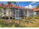 A cozy screened lanai, furnished and perfect for relaxing while enjoying the pleasant outdoor ambiance at 446 Pinewood Lake Dr, Venice, FL 34285