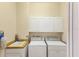 Laundry room with a sink, cabinets, washer, and dryer at 446 Pinewood Lake Dr, Venice, FL 34285
