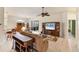 Comfortable living room with tile floors, a ceiling fan, and sliding glass doors to an outdoor patio at 446 Pinewood Lake Dr, Venice, FL 34285