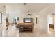 Spacious living room features tile flooring, a ceiling fan, and lots of natural light at 446 Pinewood Lake Dr, Venice, FL 34285