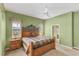 Cozy main bedroom featuring carpet floors, an iron bed frame, and ensuite bathroom at 446 Pinewood Lake Dr, Venice, FL 34285