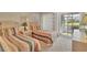 Cozy bedroom featuring twin beds and a sliding glass door to the outside at 454 Cerromar Rd # 172, Venice, FL 34293
