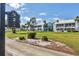Condo complex with community signage, blue exteriors, and screened lanais at 454 Cerromar Rd # 172, Venice, FL 34293