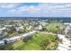 Aerial view of a golf community with lush green fairways and multiple condo buildings at 454 Cerromar Rd # 172, Venice, FL 34293