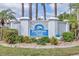 Community sign for Farmington Vistas, surrounded by lush greenery and palm trees at 454 Cerromar Rd # 172, Venice, FL 34293