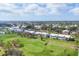 Aerial view of blue and white condo community with well-manicured golf course at 454 Cerromar Rd # 172, Venice, FL 34293