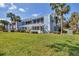 Light blue two-story condo with a well-maintained lawn and palm trees at 454 Cerromar Rd # 172, Venice, FL 34293
