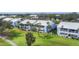 Aerial view of a blue and white two-story condo building with well-manicured landscaping at 454 Cerromar Rd # 172, Venice, FL 34293