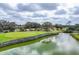 Scenic golf course view featuring a green and serene water hazard at 454 Cerromar Rd # 172, Venice, FL 34293