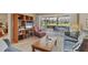 Cozy living room with a ceiling fan and view of the lawn at 454 Cerromar Rd # 172, Venice, FL 34293