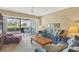 Comfortable living room featuring a ceiling fan and sliding glass door to the patio at 454 Cerromar Rd # 172, Venice, FL 34293