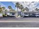 Covered carport parking at the condo with mature landscaping and sidewalks at 454 Cerromar Rd # 172, Venice, FL 34293