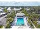 Aerial view of a community pool with lounge chairs and lush landscaping at 454 Cerromar Rd # 172, Venice, FL 34293