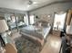 Serene bedroom with patterned wallpaper, mirrored closet doors, and a comfortable bed at 473 Sharks Pt, North Port, FL 34287