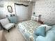 Quaint bedroom showcasing a cozy bed, decorative wallpaper, and coordinating furniture at 473 Sharks Pt, North Port, FL 34287
