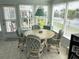 Cozy dining area with lake views, showcasing a round table and wicker chairs at 473 Sharks Pt, North Port, FL 34287