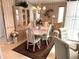 Elegant dining room with chandelier lighting, dining table, chairs, china cabinet and patterned wallpaper at 473 Sharks Pt, North Port, FL 34287