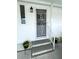 Inviting entrance with secure door and decorative bars, featuring potted plants at 473 Sharks Pt, North Port, FL 34287