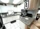 Efficient kitchen space with granite counters, white cabinets and stainless appliances at 473 Sharks Pt, North Port, FL 34287