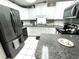Efficient kitchen space with granite counters, white cabinets and stainless appliances at 473 Sharks Pt, North Port, FL 34287