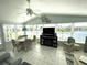 Bright, airy living room with lake view, tile floors, and comfortable seating at 473 Sharks Pt, North Port, FL 34287