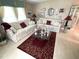 Inviting living room with matching sofas, decorative rug, glass table and coordinated decor at 473 Sharks Pt, North Port, FL 34287