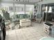 Comfortable living room area with wicker sofa and seating and views of lake at 473 Sharks Pt, North Port, FL 34287