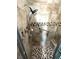 Accessible shower with safety bar, adjustable shower head, and tiled walls and floor at 473 Sharks Pt, North Port, FL 34287