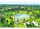 Aerial view of Warm Mineral Springs Park and Lagoon with lush landscaping and clear water at 5051 Greenway Dr, North Port, FL 34287