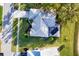 An aerial view of a lovely home featuring a pool, lush landscaping, and a well maintained yard at 5051 Greenway Dr, North Port, FL 34287