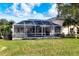 Spacious backyard with screened in pool perfect for enjoying the outdoors at 5051 Greenway Dr, North Port, FL 34287