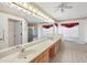 Spacious bathroom featuring a large mirror, double sink, and luxurious soaking tub at 5051 Greenway Dr, North Port, FL 34287