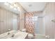 Well-lit bathroom featuring a shower/tub combo and vanity at 5051 Greenway Dr, North Port, FL 34287