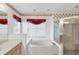 Bright bathroom featuring a shower and separate tub under a red-curtained window at 5051 Greenway Dr, North Port, FL 34287