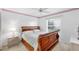 Serene bedroom features a wooden sleigh bed and soft, natural lighting at 5051 Greenway Dr, North Port, FL 34287