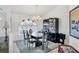Dining room with modern chandelier, dark furnishings, and large window at 5051 Greenway Dr, North Port, FL 34287